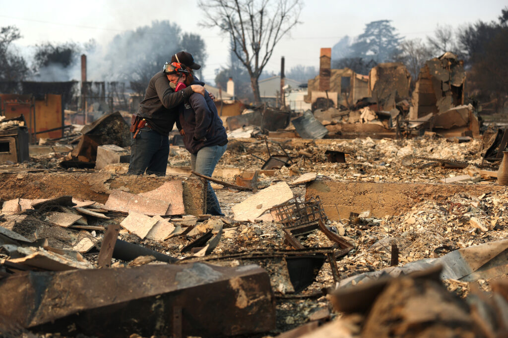 Khaled Fouad (left) and Mimi Laine embrace as they inspect a family member’s property that was destroyed by the Eaton Fire on Jan. 9 in Altadena, Calif. Credit: Justin Sullivan/Getty Images
