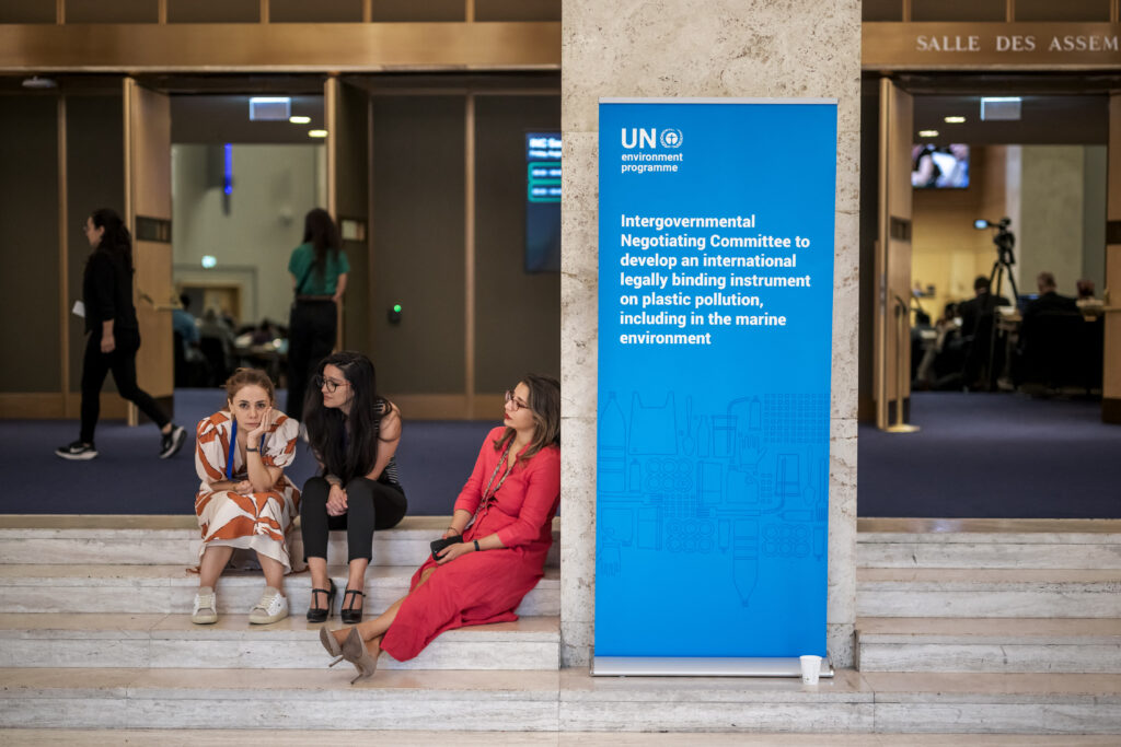 Delegates rest outside of the assembly hall in Geneva, after talks aimed at striking a landmark treaty on plastic pollution ended with no consensus. Credit: Fabrice Coffrini/AFP via Getty Images