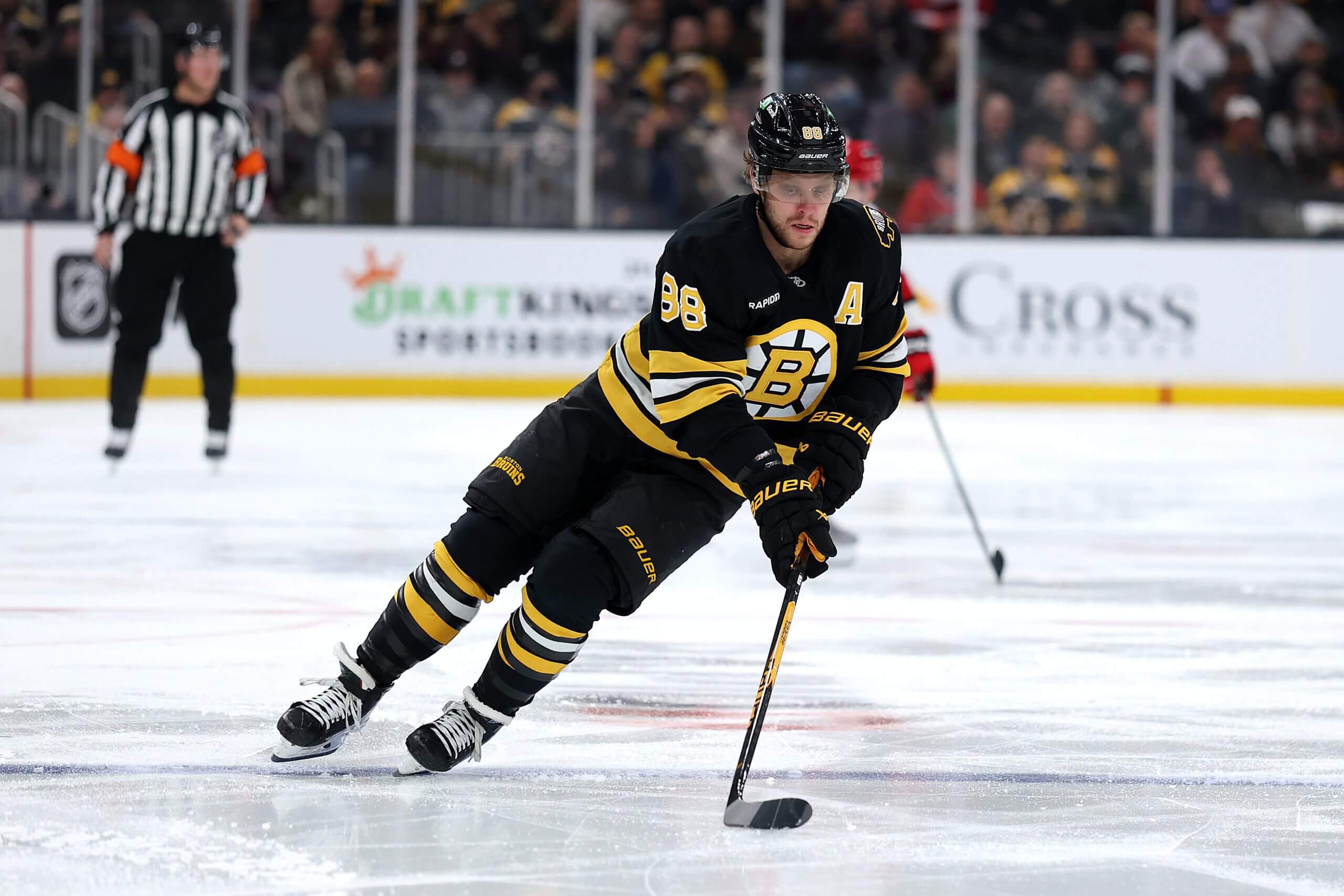 David Pastrnak skates with the puck into the offensive zone.