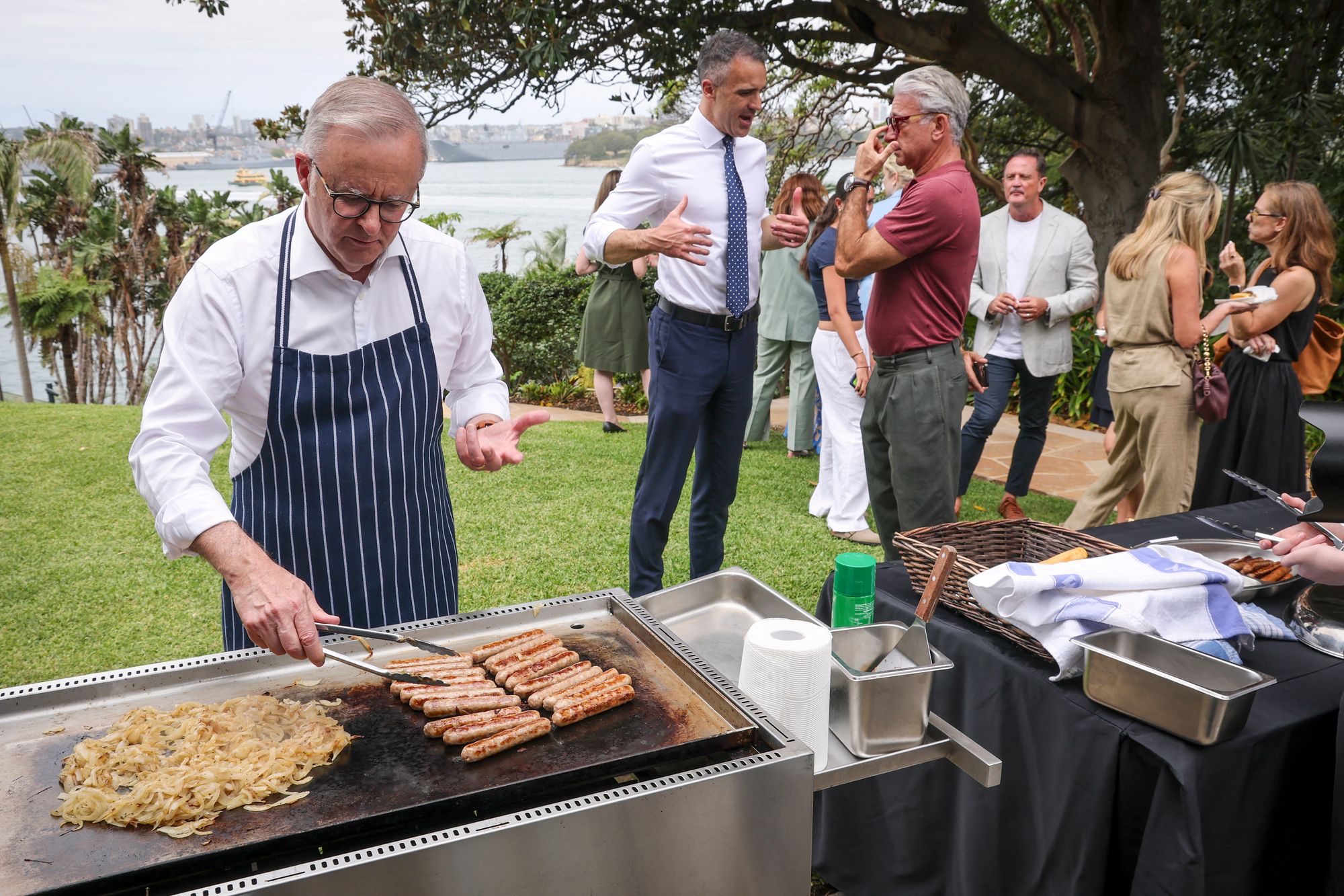 Anthony Albanese cooks sausages on a barbecue during an official function to mark the start of Australia's social media ban in Sydney on 10 December 2025