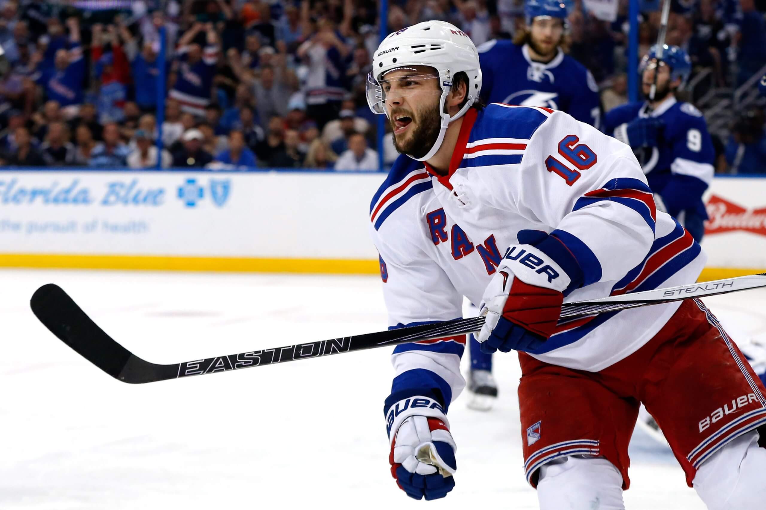 Derick Brassard sneers after scoring a goal, with two morose Lightning players partially visible over his shoulder.