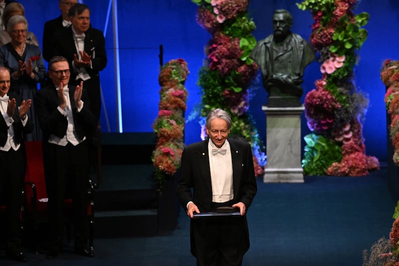 Nobel Prize in Physics 2024 laureate and British-Canadian computer scientist Geoffrey Hinton poses with his award he was given by King Carl XVI Gustaf of Sweden (R) during the Nobel Prize award ceremony at the Concert Hall in Stockholm, Sweden on December 10, 2024. (Photo by Jonathan NACKSTRAND / AFP) (Photo by JONATHAN NACKSTRAND/AFP via Getty Images)