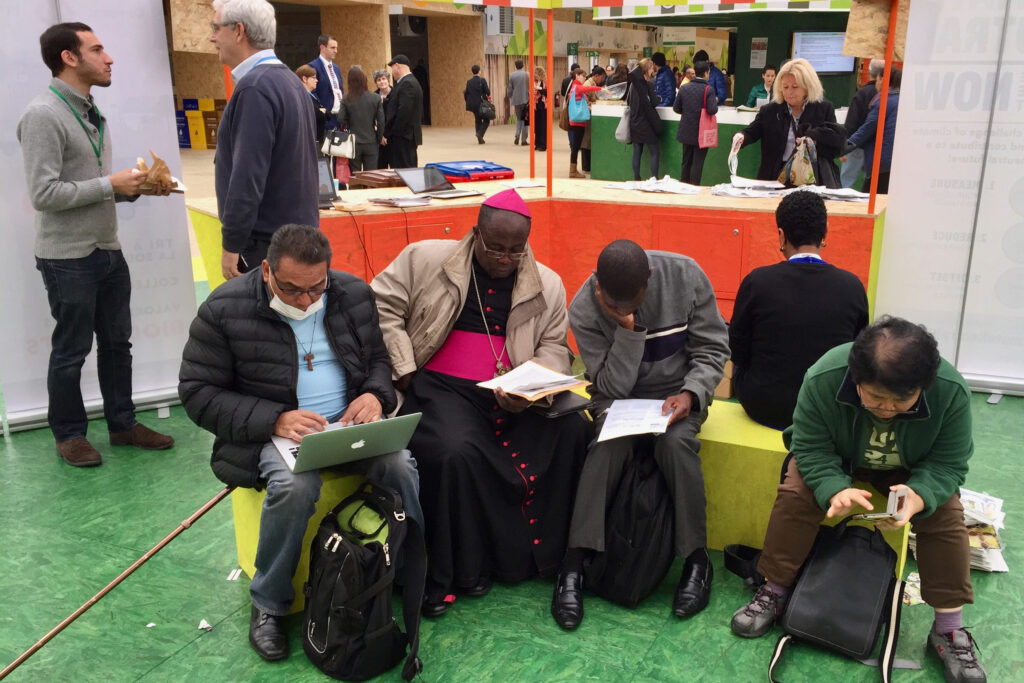 Negotiators and observers at COP21 in Paris clustered in the public Green Zone to reach one of the early drafts of what would become the Paris Agreement.