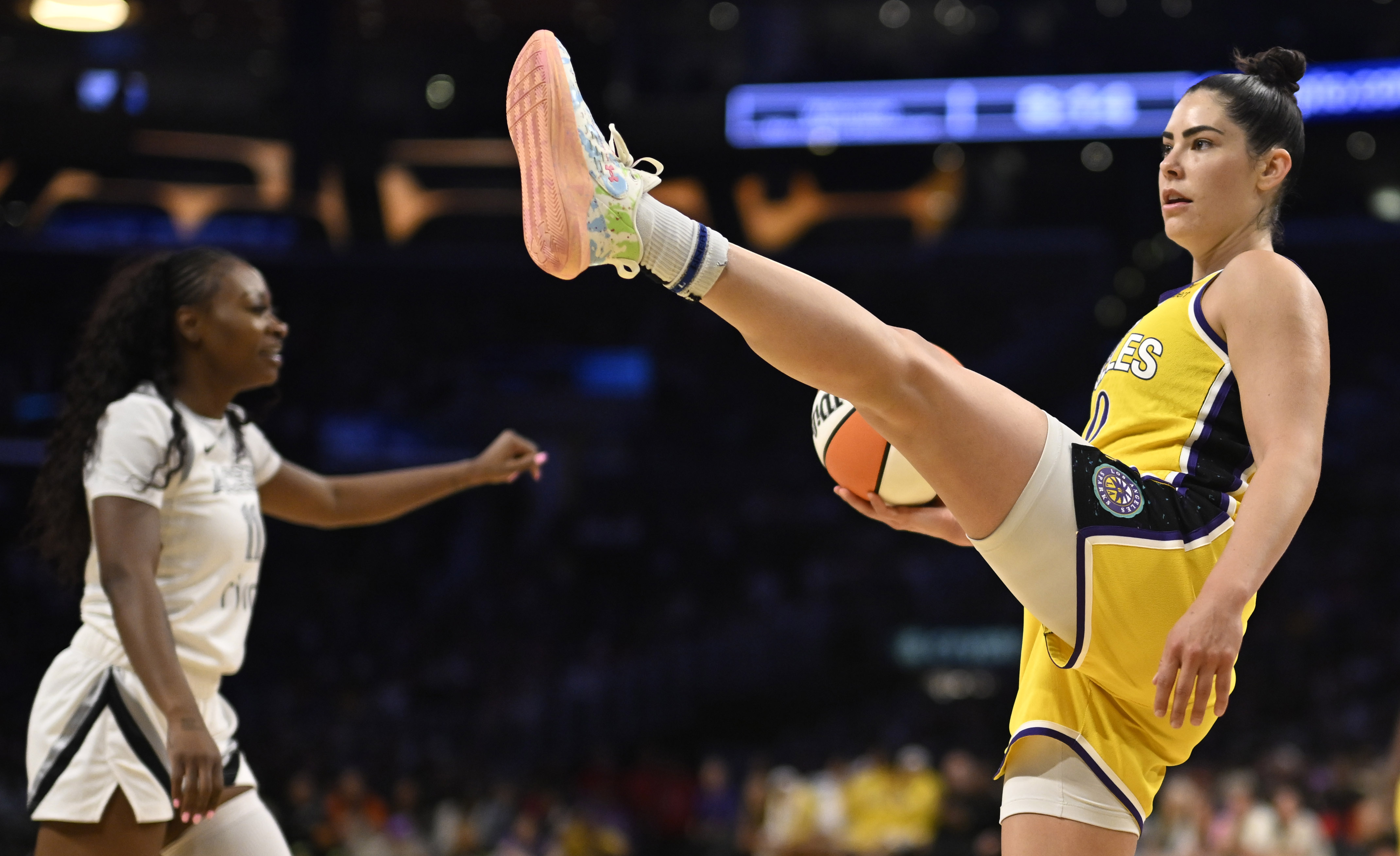 Sparks guard Kelsey Plum, right, reacts as Las Vegas Aces...