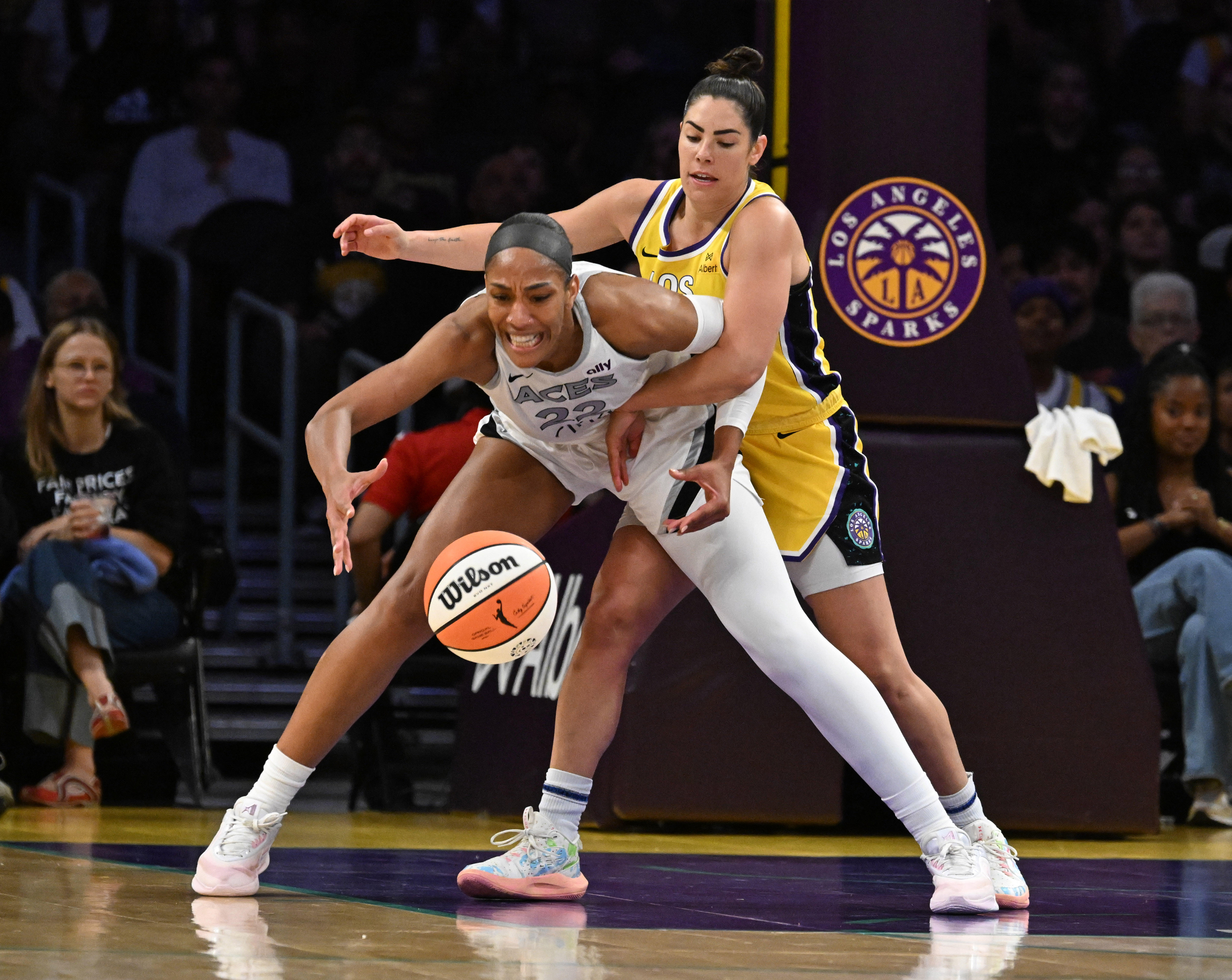 Sparks guard Kelsey Plum, right, fouls Las Vegas Aces center...