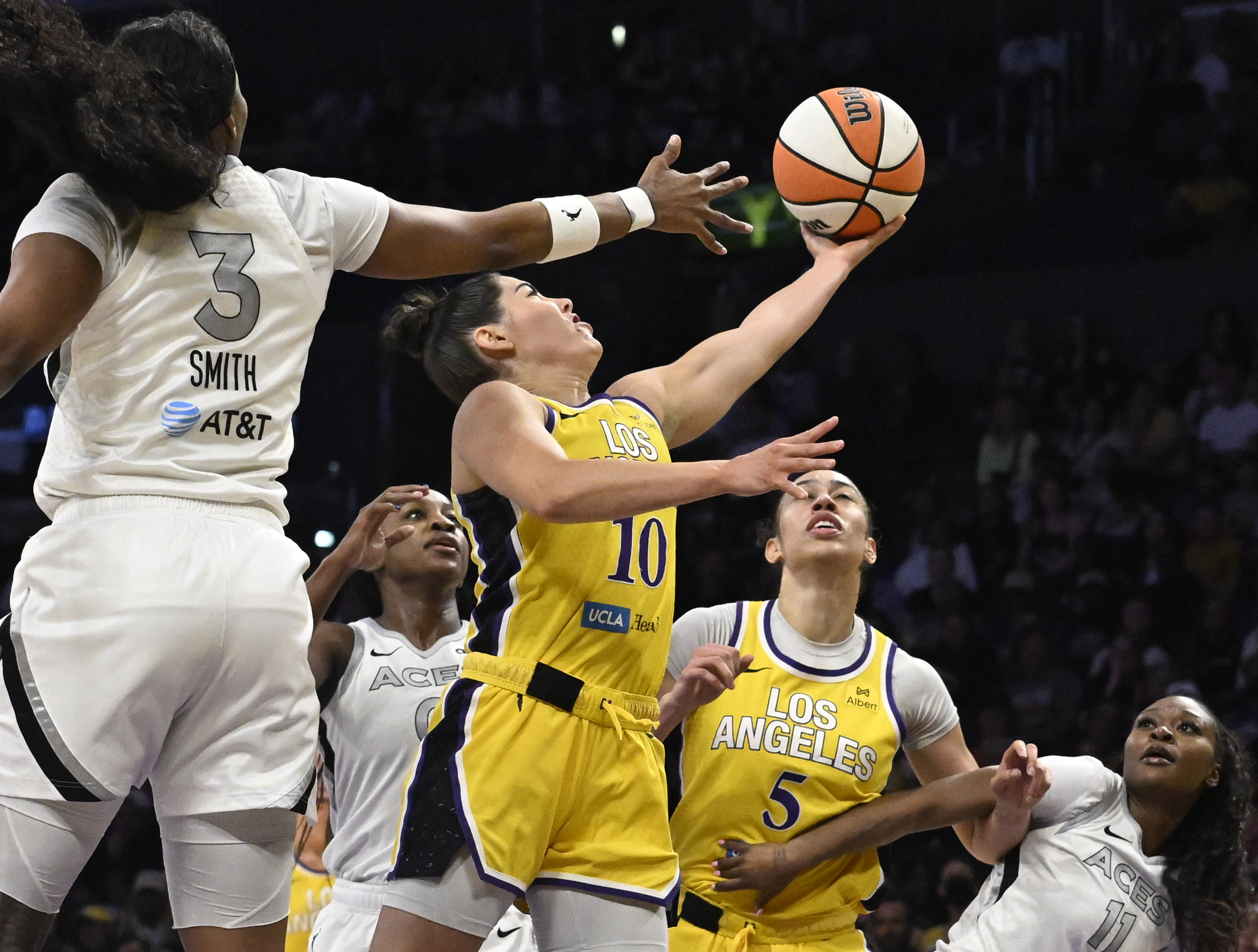 Sparks guard Kelsey Plum drives to the basket in front...