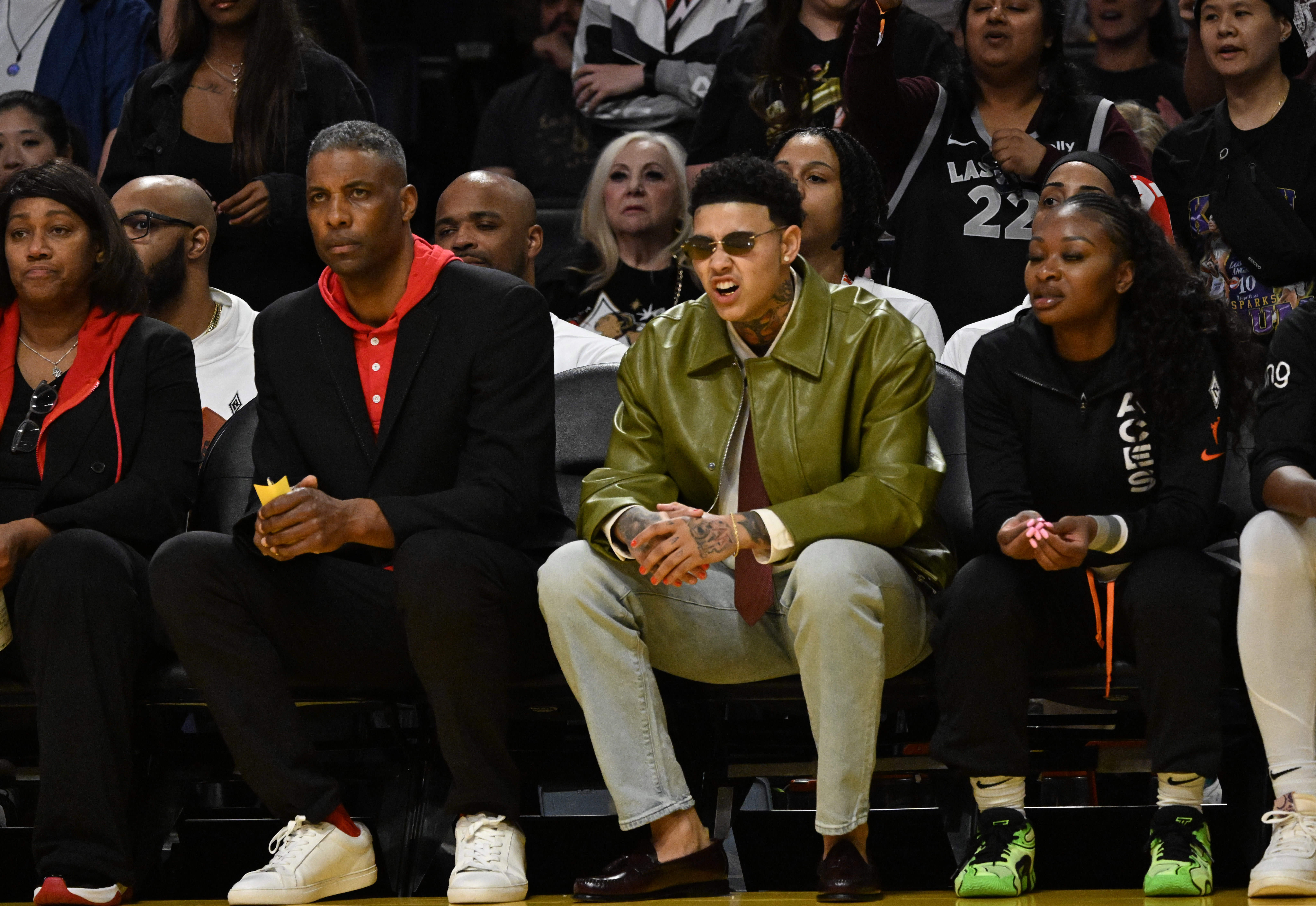 LAs Vegas Aces forward Kierstan Bell, center, watches from the...