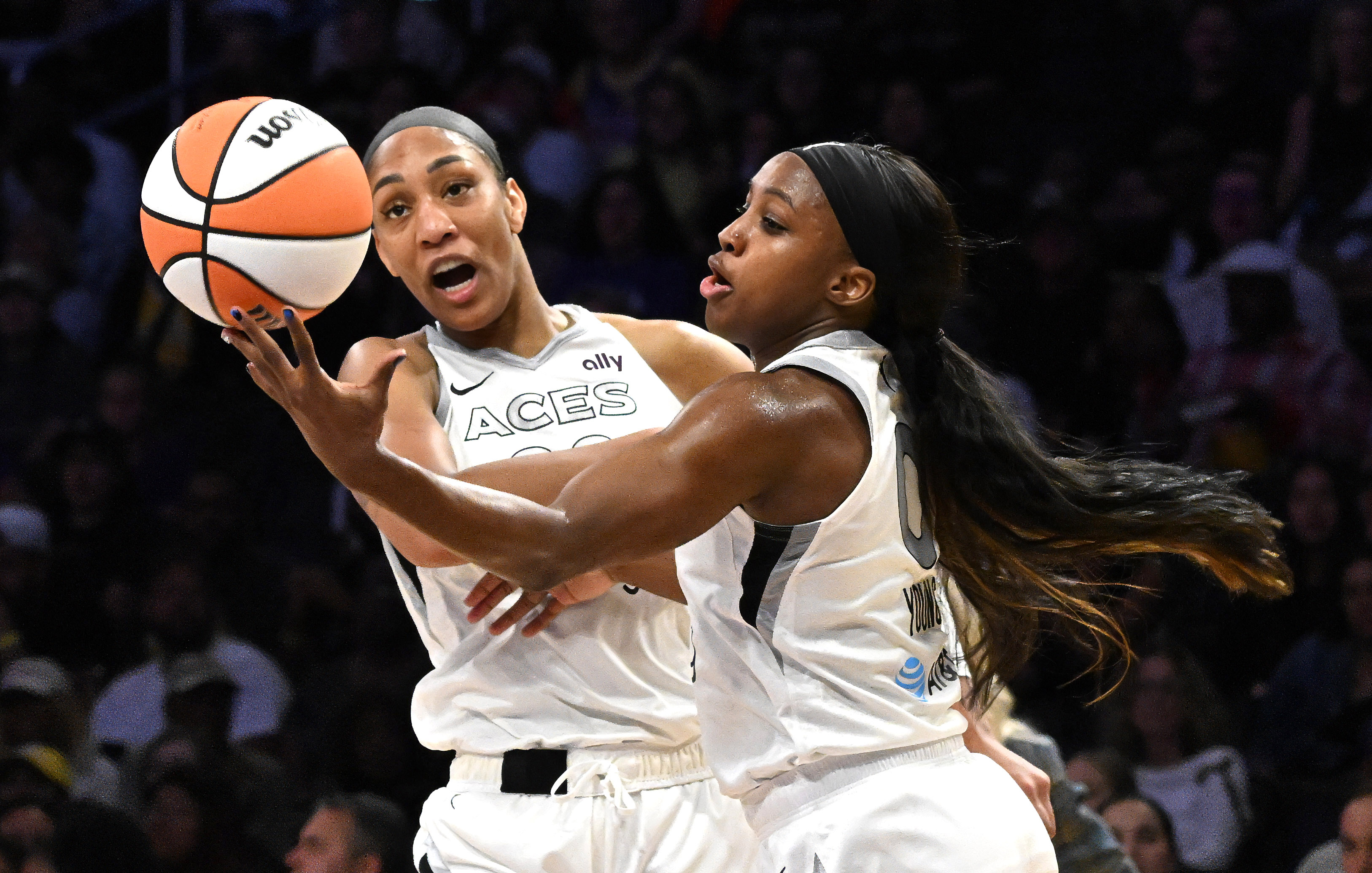 Las Vegas Aces guard Jackie Young, right, reaches for a...