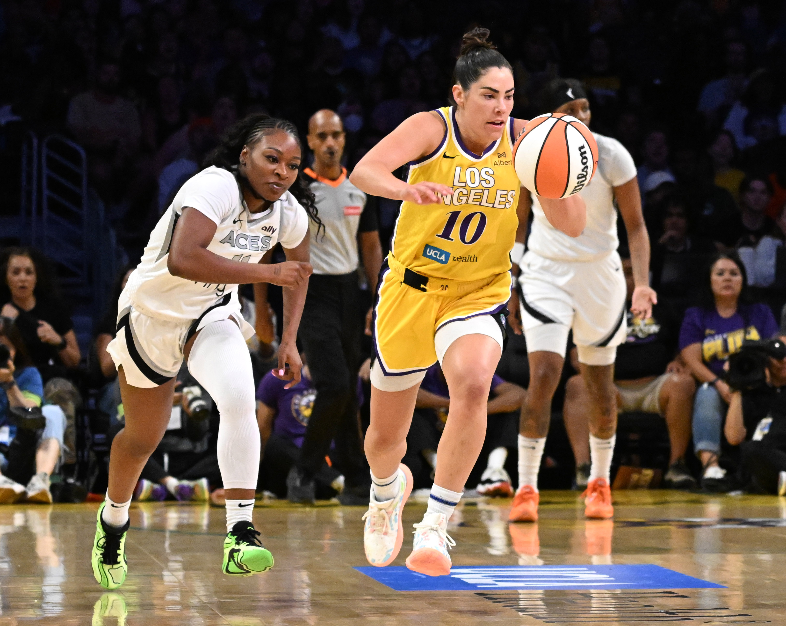 Sparks guard Kelsey Plum steals the ball and heads up...