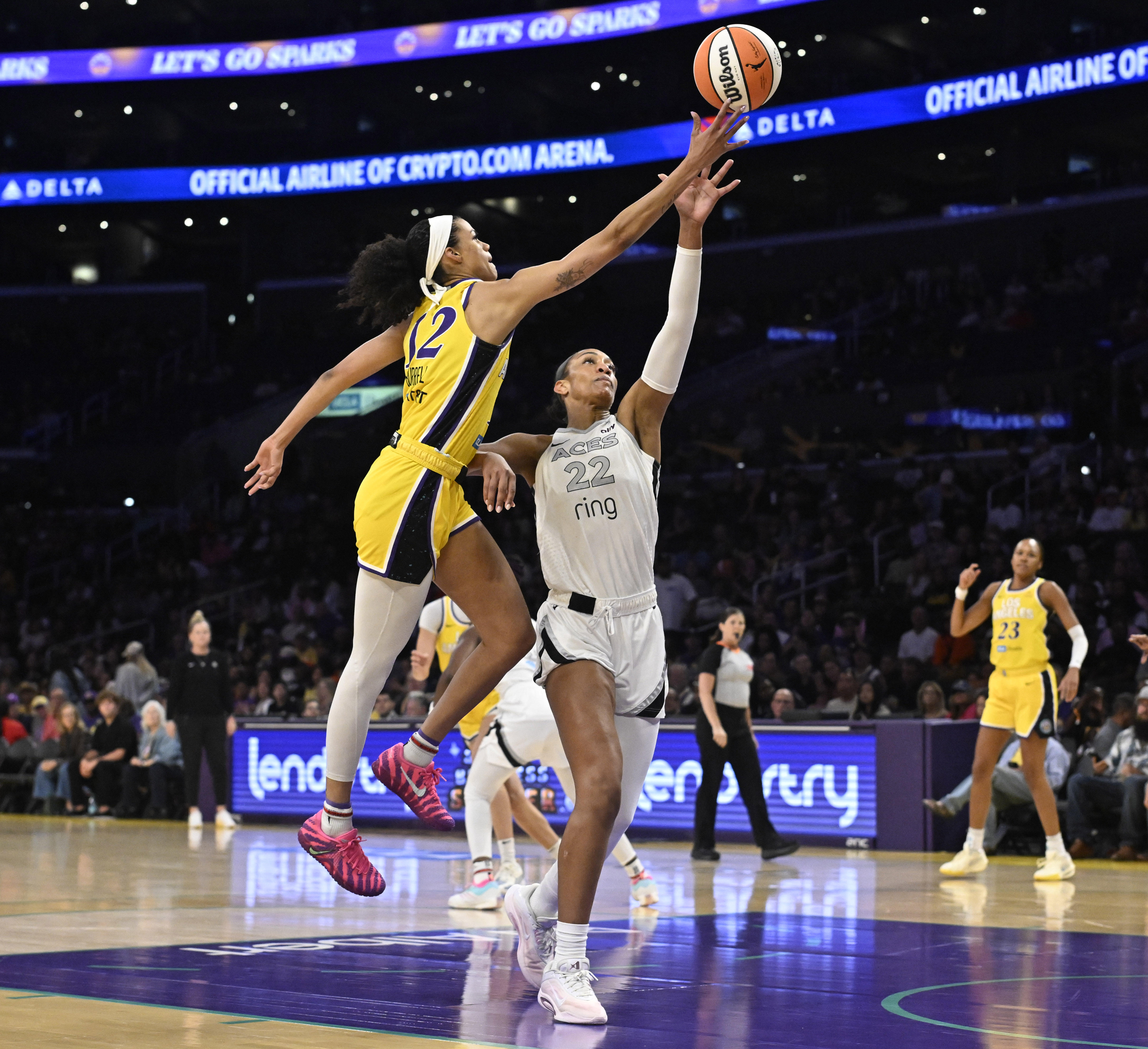 Sparks guard Rae Burrell, left, puts up a shot as...