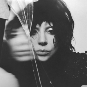 Black-and-white photo of Gaga's face near a piece of glass