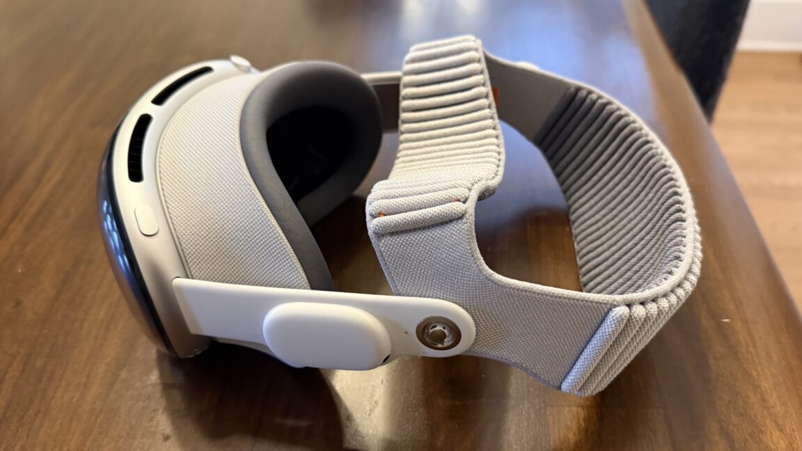 A headset sits on a wood table