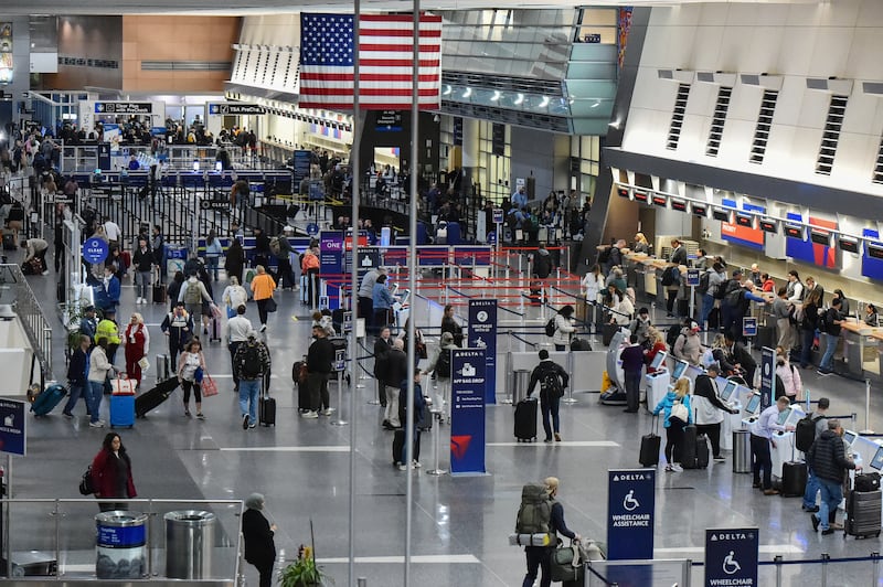 Travelers check in for flights at Boston Logan International Airport in Boston, Massachusetts on November 10, 2025. The US Senate took a major step on November 9 toward ending the longest government shutdown in American history when it cleared the way for a formal debate on a motion to resume funding to federal agencies. The deal between Democratic and Republican senators, just the first step to halting the shutdown, came as authorities warned US air travel could soon "slow to a trickle" as thousands more flights were cancelled or delayed over the weekend. (Photo by Joseph Prezioso / AFP) (Photo by JOSEPH PREZIOSO/AFP via Getty Images)