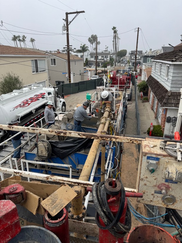 Crews and drilling equipment squeeze into a Balboa Peninsula neighborhood trying to cap a 1920s-era oil well that is leaking. (Courtesy of Mark Vukojevic)