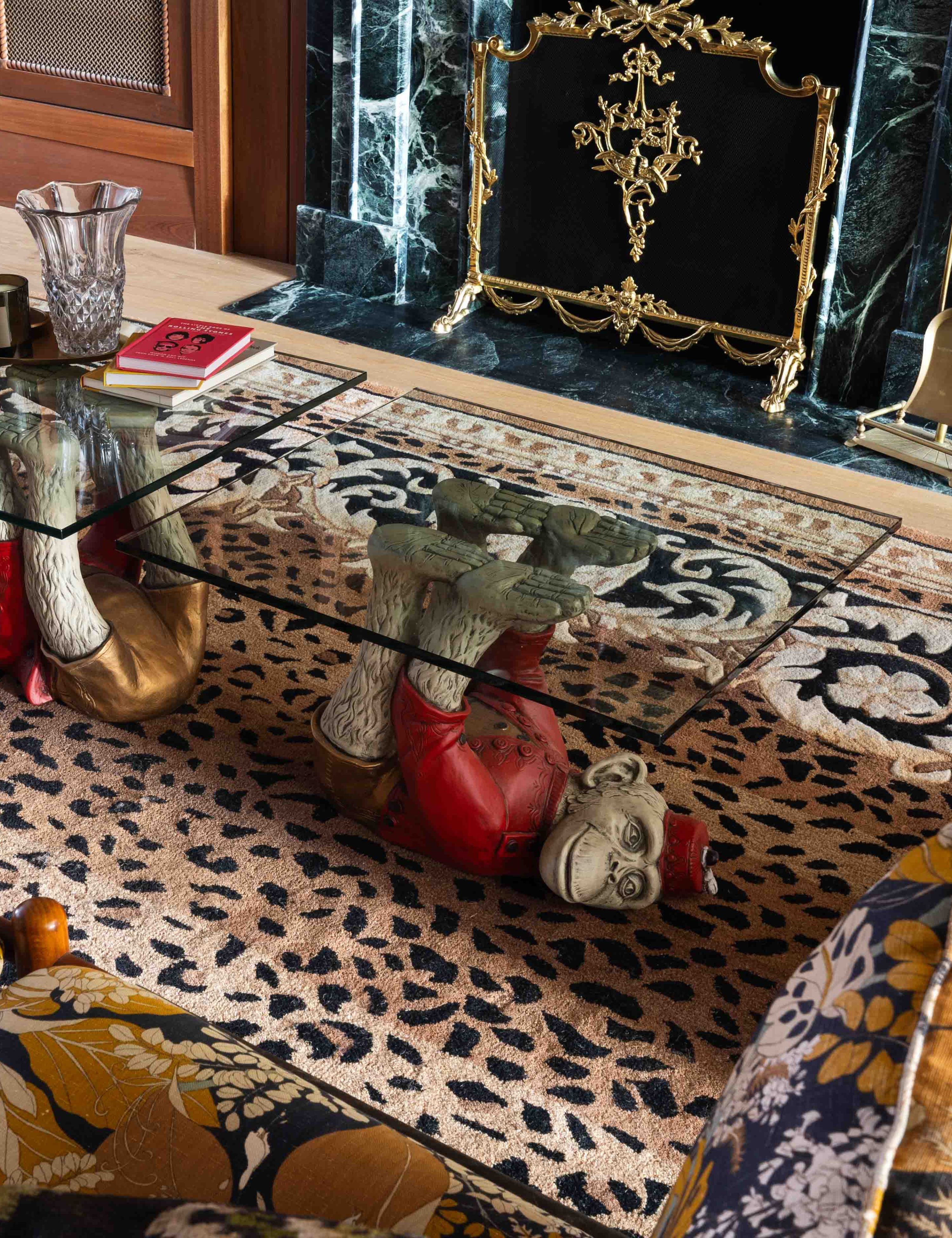 Pattern-filled parlor room featuring a leopard print rug, monkey motif coffee table, and floral sofa