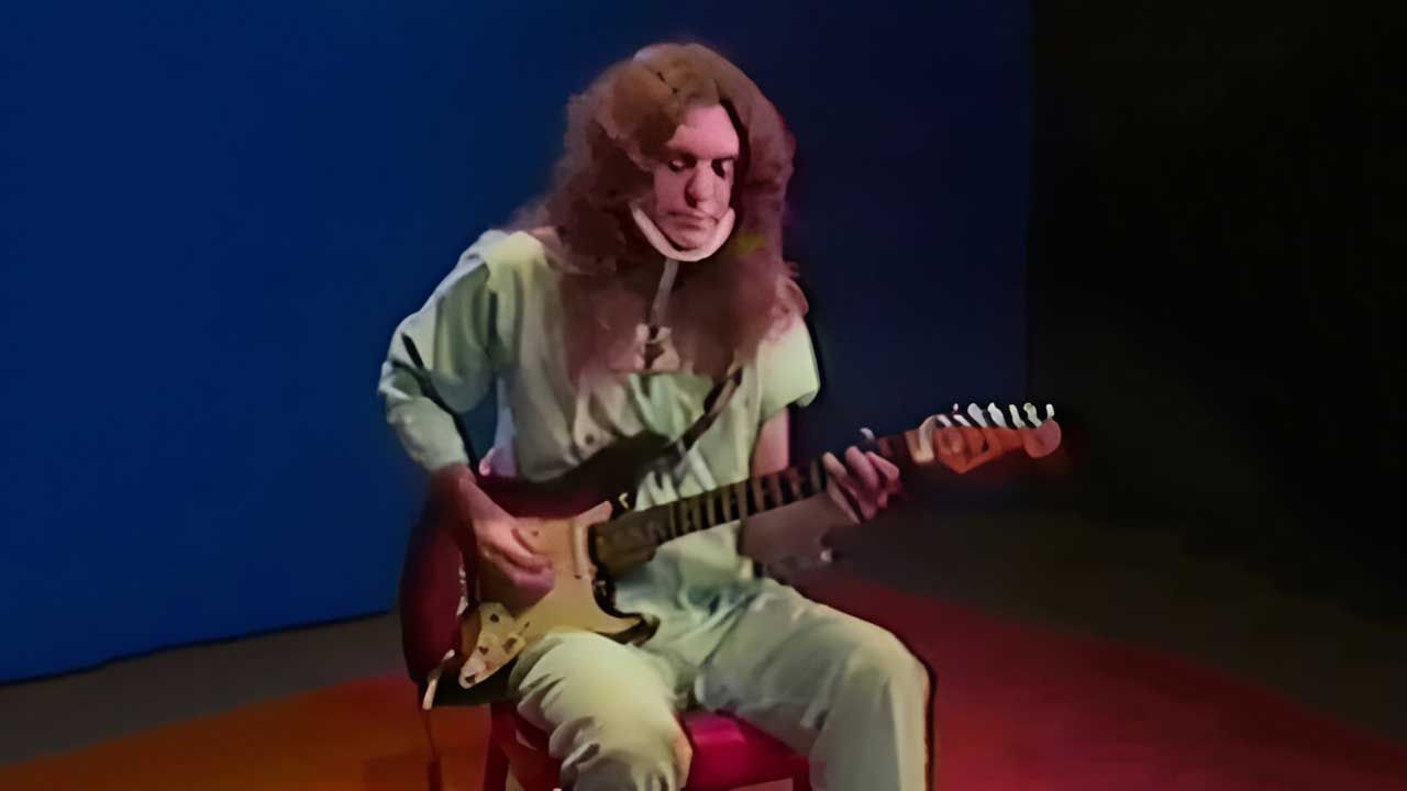 Allen Collins in hospital pyjamas playing guitar