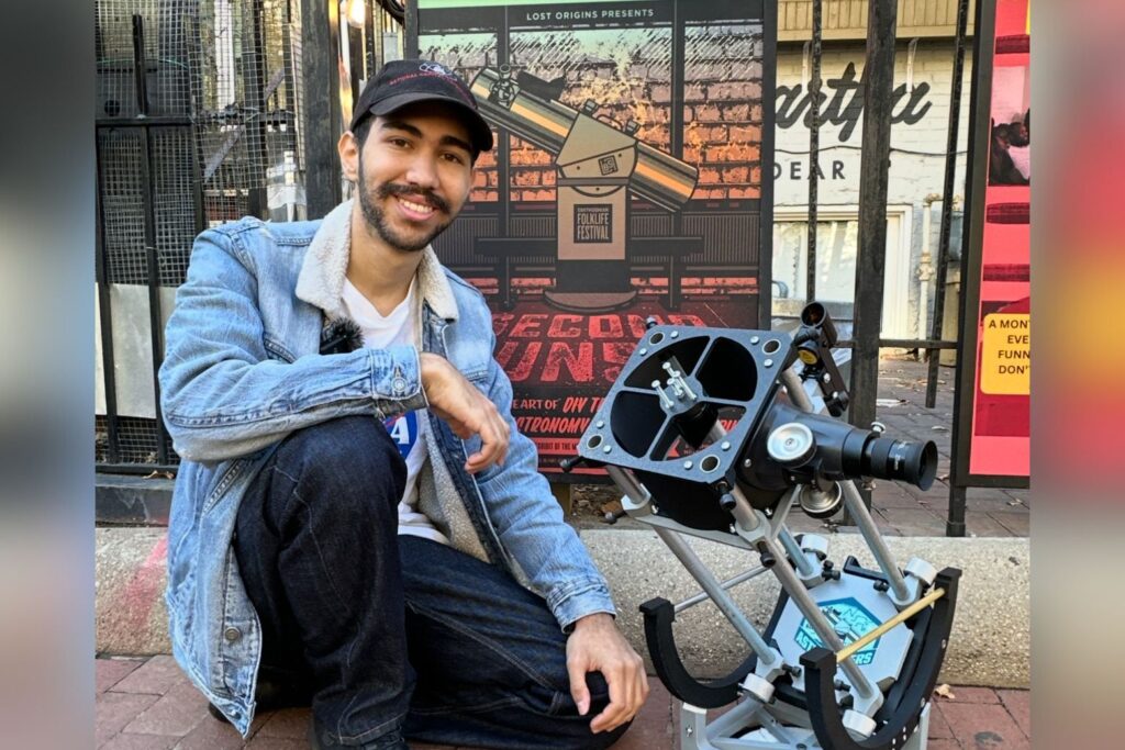 Gael Gomez poses with telescope