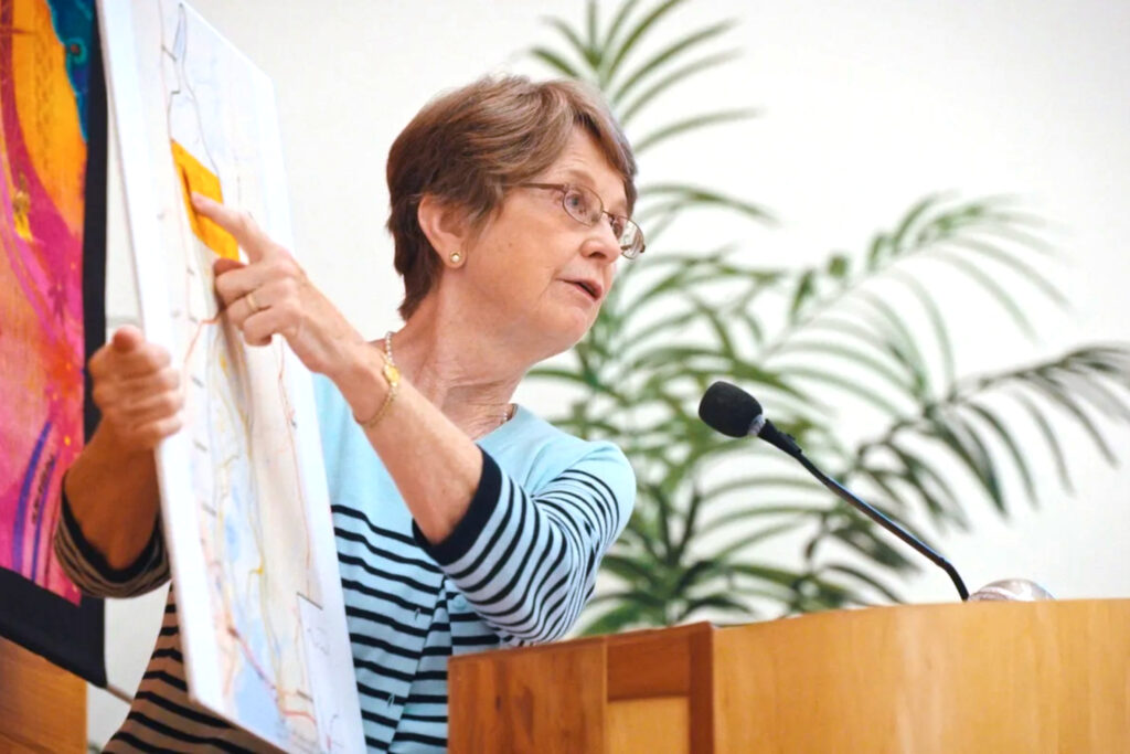 Diane Thomas shows community members a hand-colored map of Plant Barry’s inundation zone. Credit: Courtesy of Sallie’s Ashes