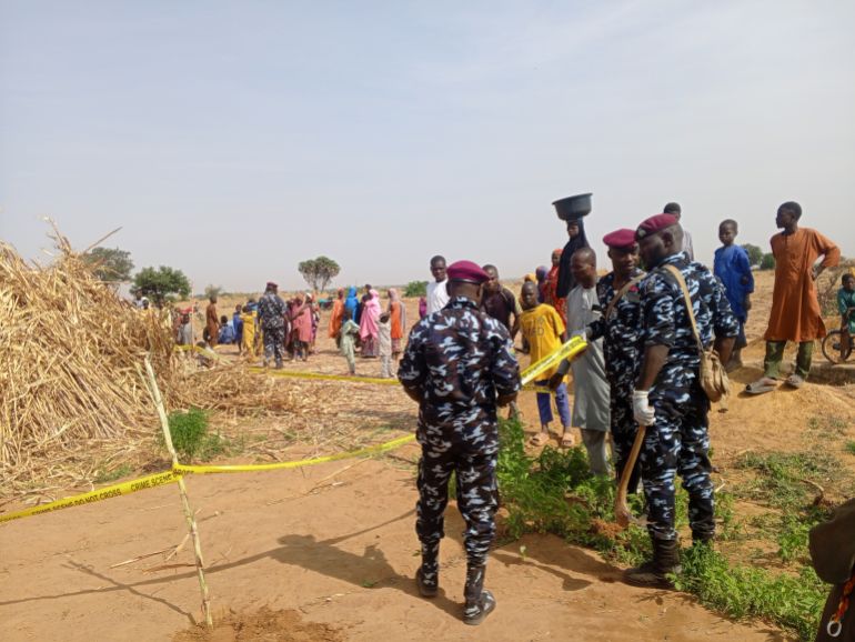 Police stand with yellow tape