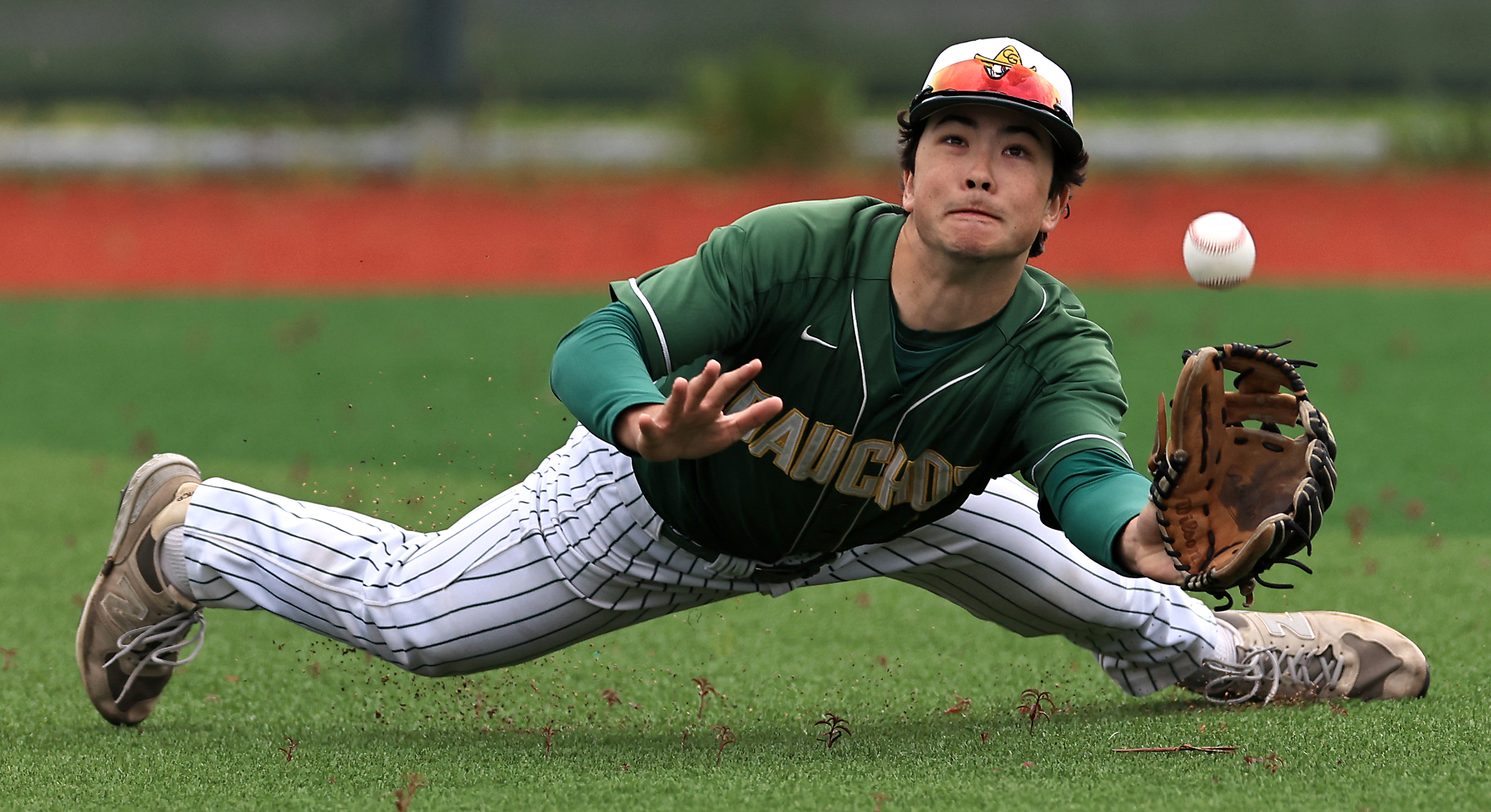 Casa Grande right fielder Gavin Lee dives for a bloop...