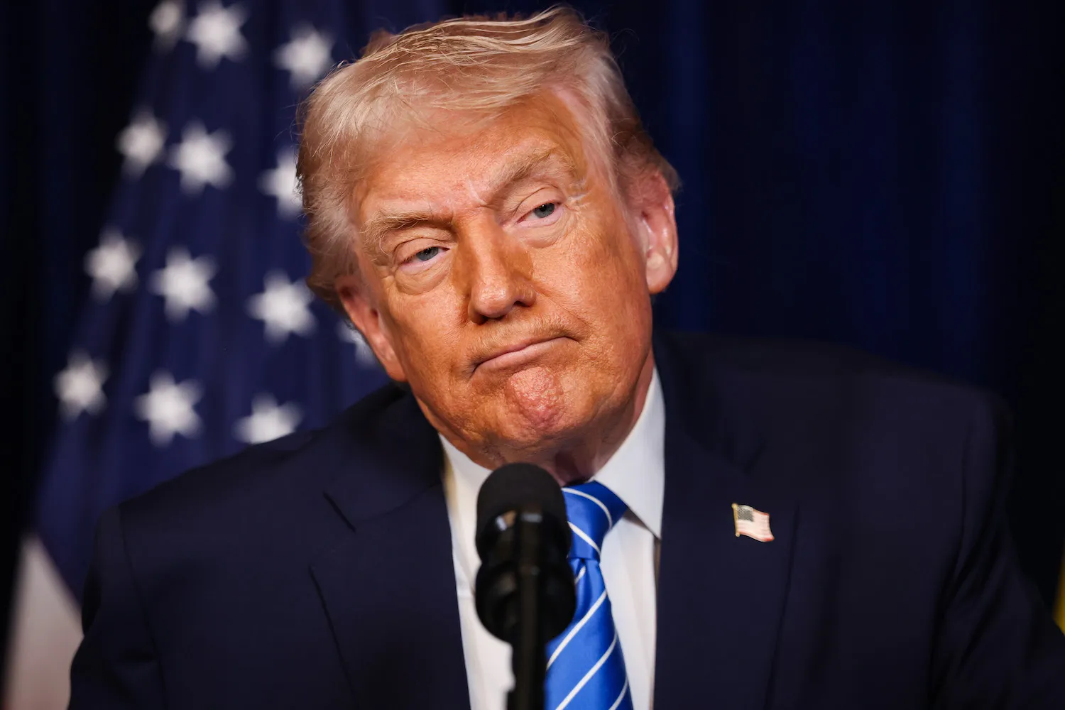 U.S. President Donald Trump listens during a press conference with Ukrainian President Volodymyr Zelensky (not pictured) in Florida.
