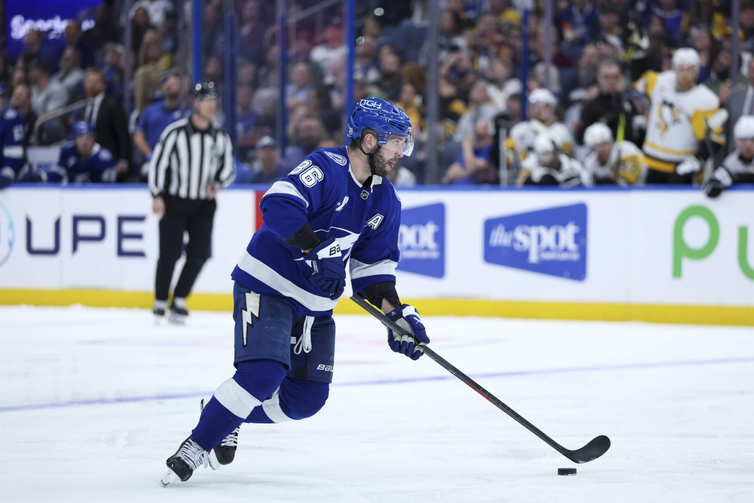 Tampa Bay's Nikita Kucherov skates up the ice with the puck against the Penguins.