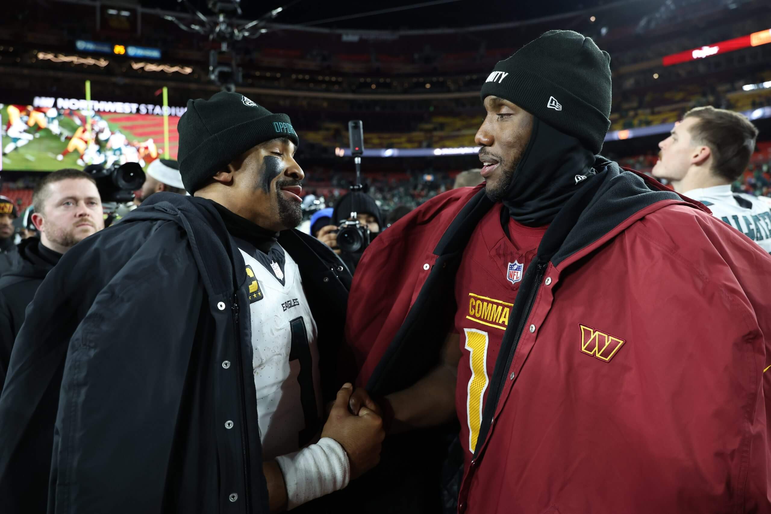 Eagles QB Jalen Hurts greets Washington's Josh Johnson after a December game.