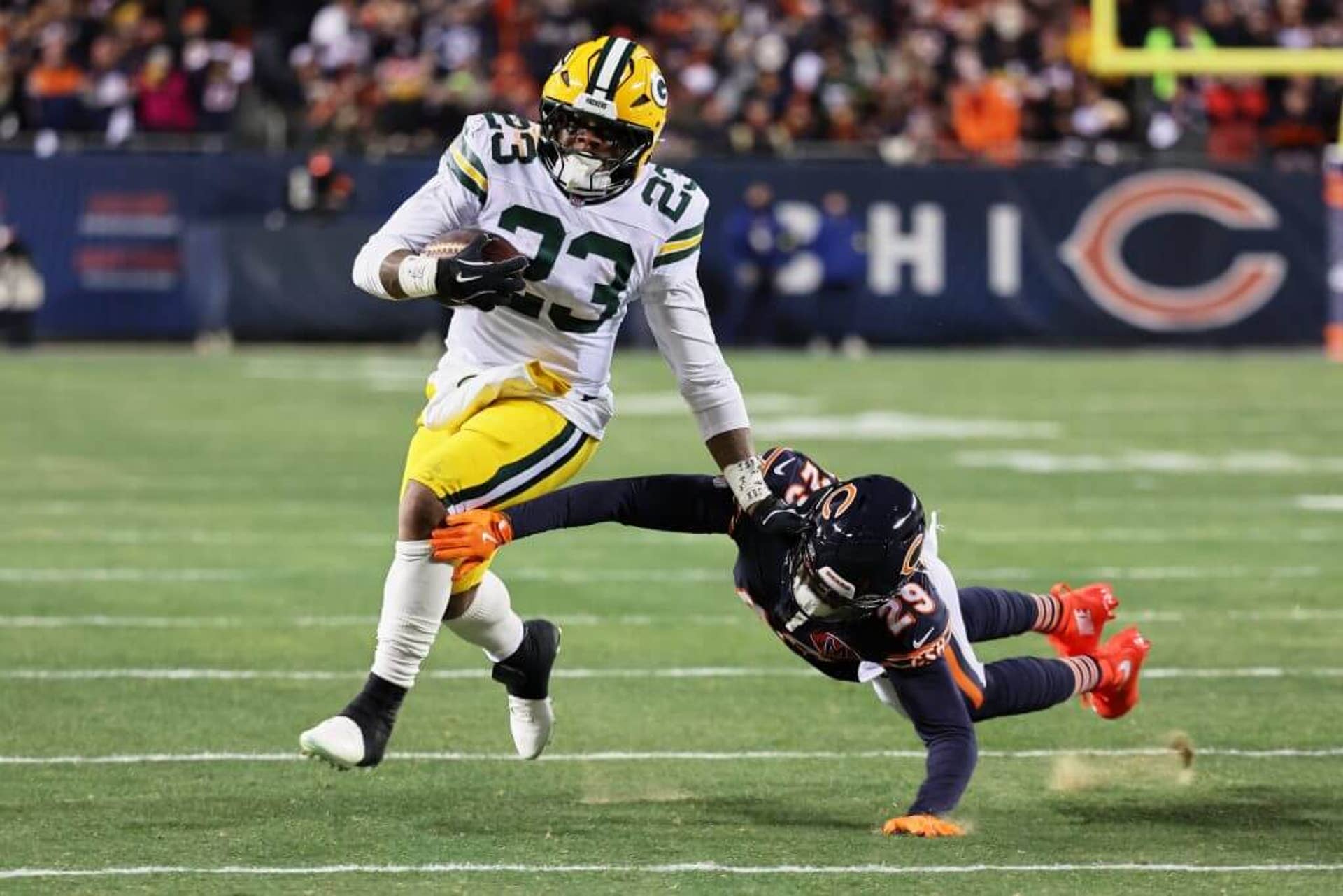 Green Bay Packers running back Emanuel Wilson runs with the ball while dodging a tackle.