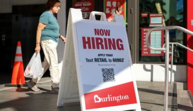 A hiring sign outside the entrance to a Burlington department store on Nov. 19 in Miami.