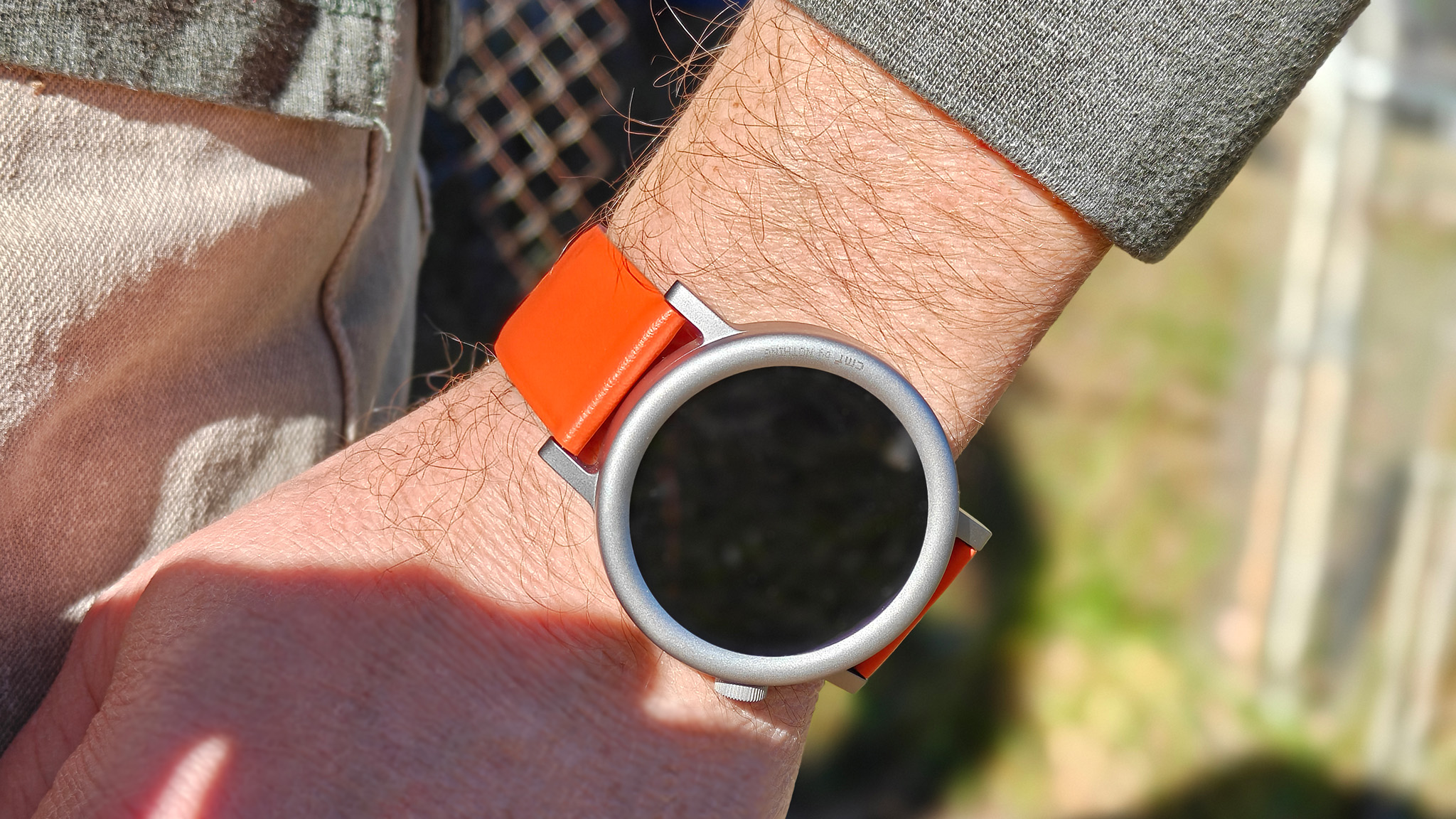 Wearing the silver CMF Watch Pro 2 with the orange band
