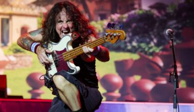 Steve Harris playing bass onstage with Iron Maiden in 2023