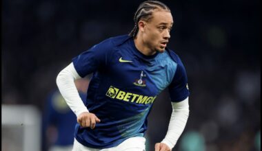 Xavi Simons runs while warming up for Tottenham.