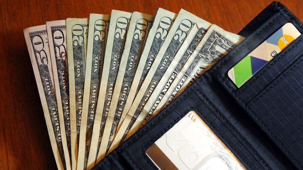 FILE - In this June 15, 2018, file photo, cash is fanned out from a wallet in North Andover, Mass. A personal loan can be a good option when you need money, but it typically requires strong credit and high income to qualify. What if you don’t meet the requirements for a personal loan? Consider several alternative ways to get money, such as family loans and cash advances.   (AP Photo/Elise Amendola, File)