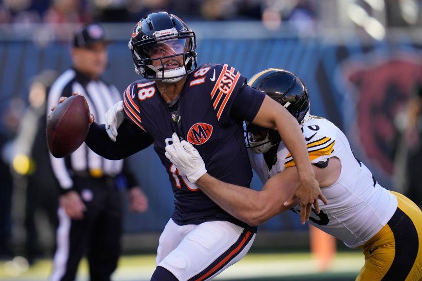 Bears quarterback Caleb Williams tries to shake off Pittsburgh's TJ Watt during a game last month.