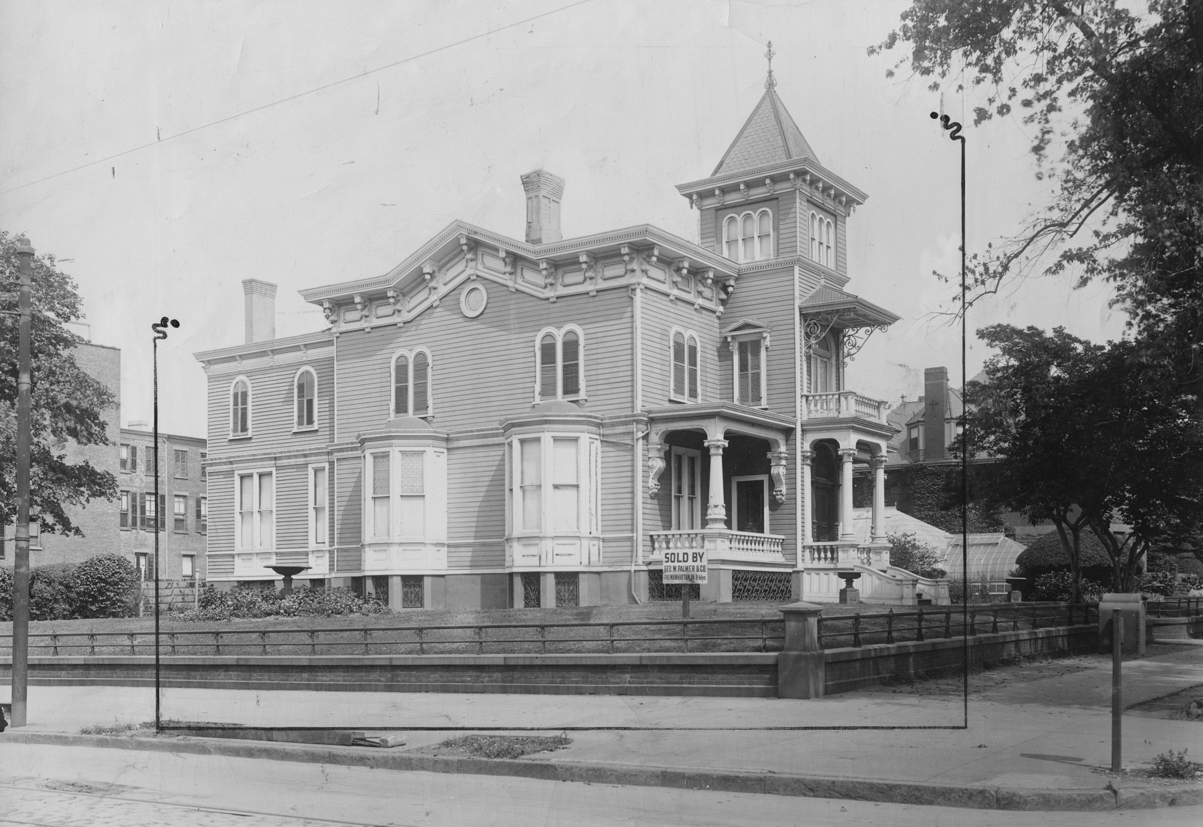 a black and white photo of a wood frame house