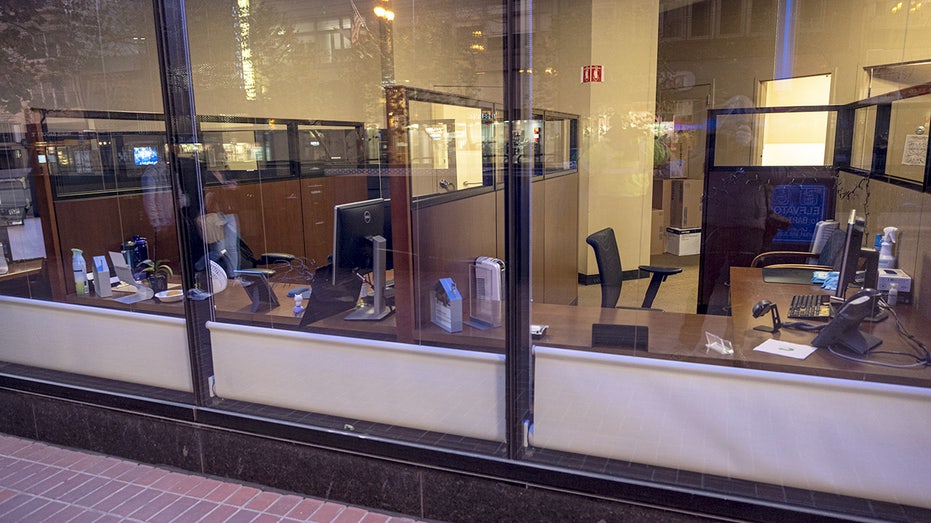 Empty office desks and cubicles through a window