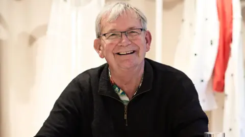 Getty Images Martin Parr, pictured smiling in a black jumper