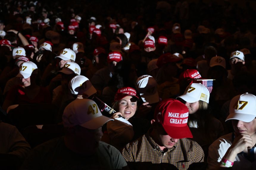 Attendees wear MAGA (Make America Great Again) hats during an 