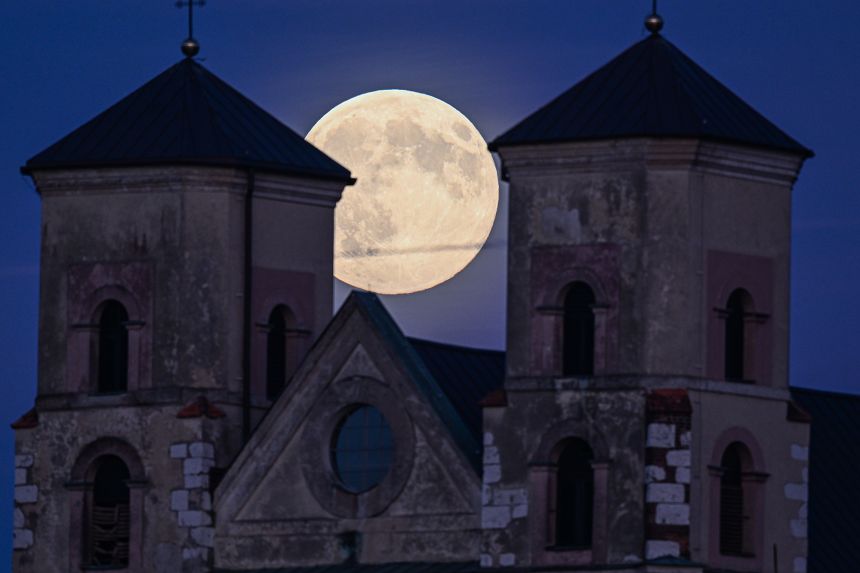 A supermoon rises behind the Benedictine Abbey in November in Kraków, Poland.