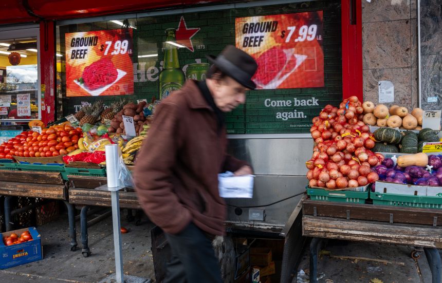 A man walks by a food market in the Brooklyn borough of New York City on November 6, 2025