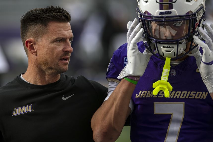 James Madison head coach Bob Chesney speaks with Jacob Thomas during the Dukes' home win against Washington State in November.
