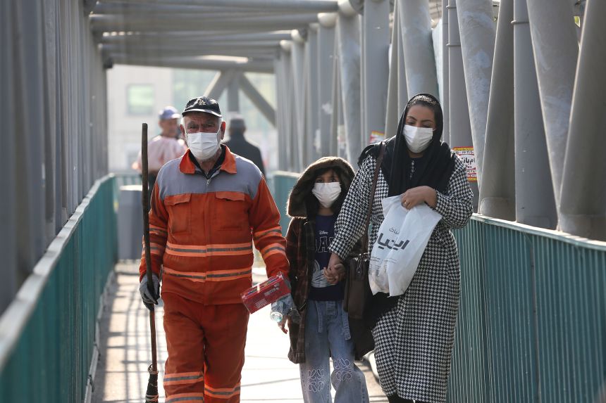 People wear masks on the street during daily life as air pollution continues to negatively impact life in Tehran, Iran on November 27, 2025.