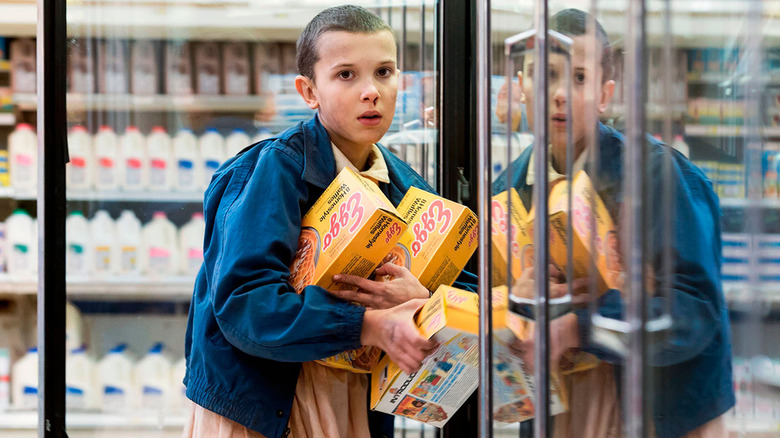 Millie Bobby Brown's Eleven grabs some Eggos in Stranger Things.