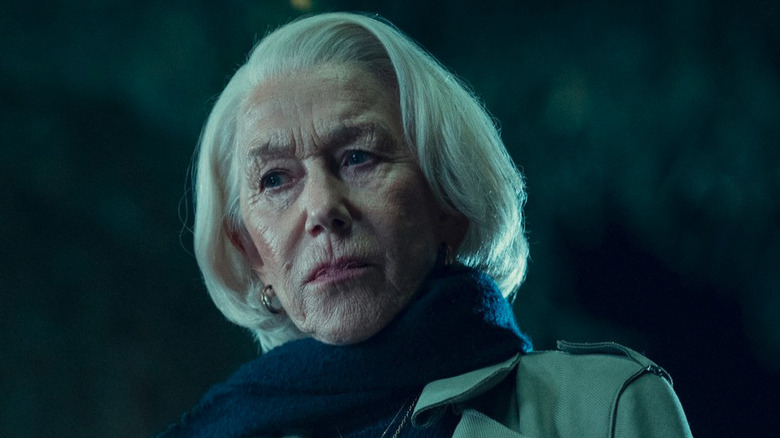 Helen Mirren looks concerned in a coat and scarf in Thursday Murder Club