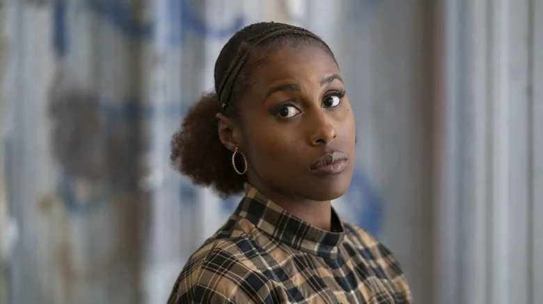 Issa Dee (Issa Rae) stands expectantly in Insecure