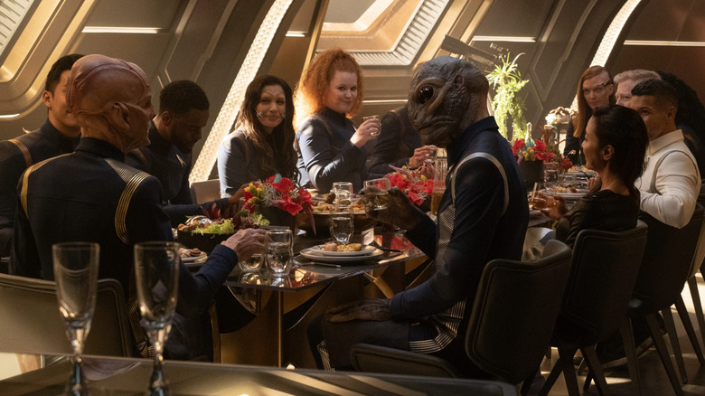 The crew of the Discovery smile and speak over a lavish dinner in Star Trek: Discovery