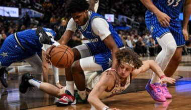 Magic guard Jase Richardson lands on top of Warriors guard Brandin Podziemski in a scramble for a loose ball during the second half on Monday, Dec. 22, 2025, in San Francisco (AP Photo/Justine Willard)