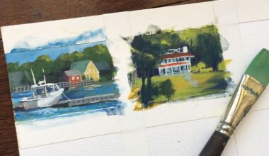 Two small landscape paintings and a paintbrush covered in paint