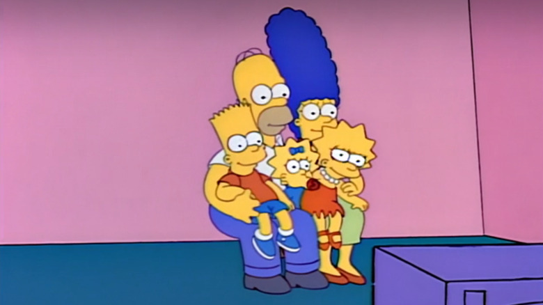 The Simpsons crowd onto a small chair in this couch gag