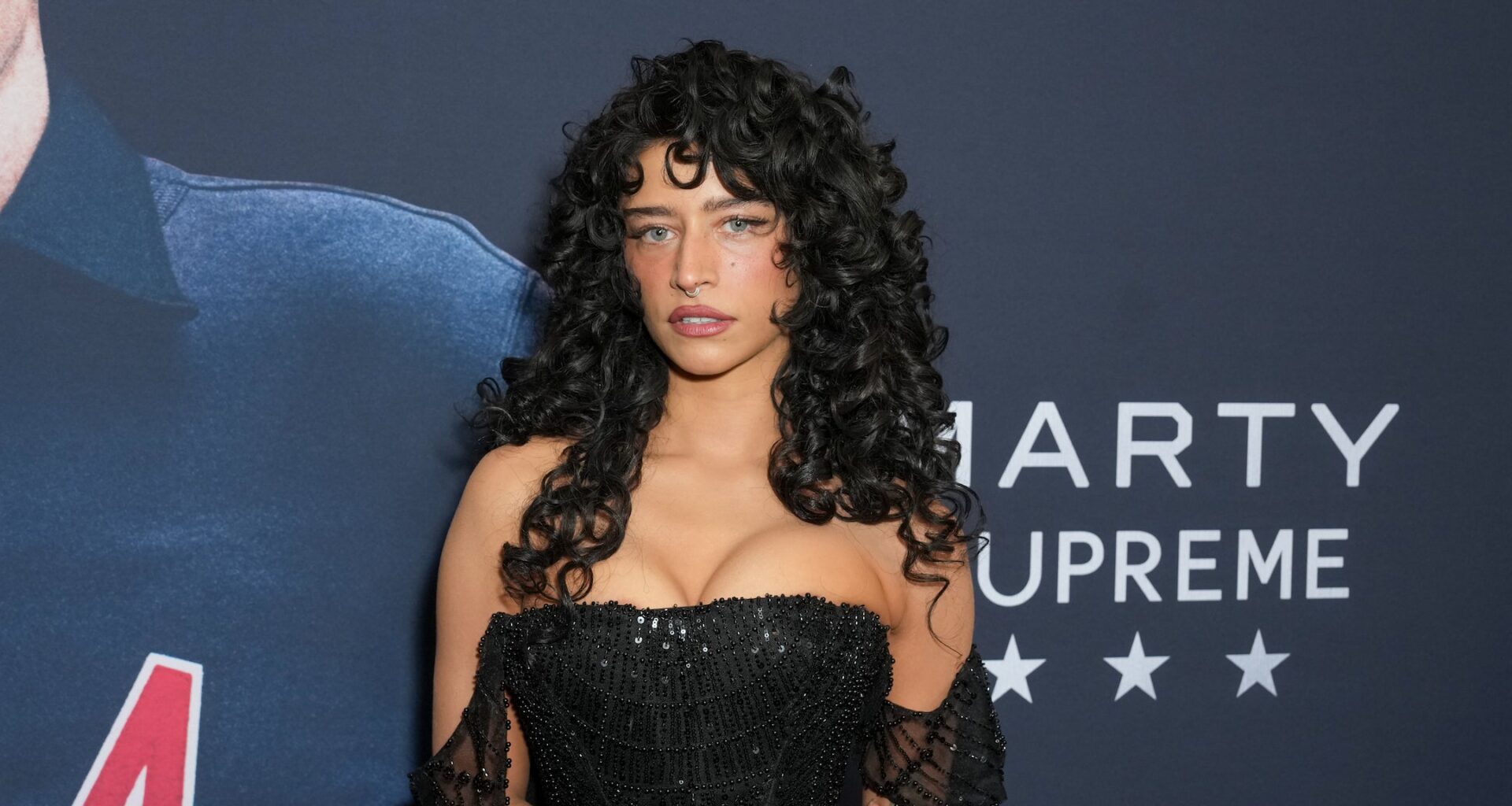 Odessa on the red carpet in a black dress.